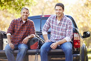 Two guys sitting on a tailgate